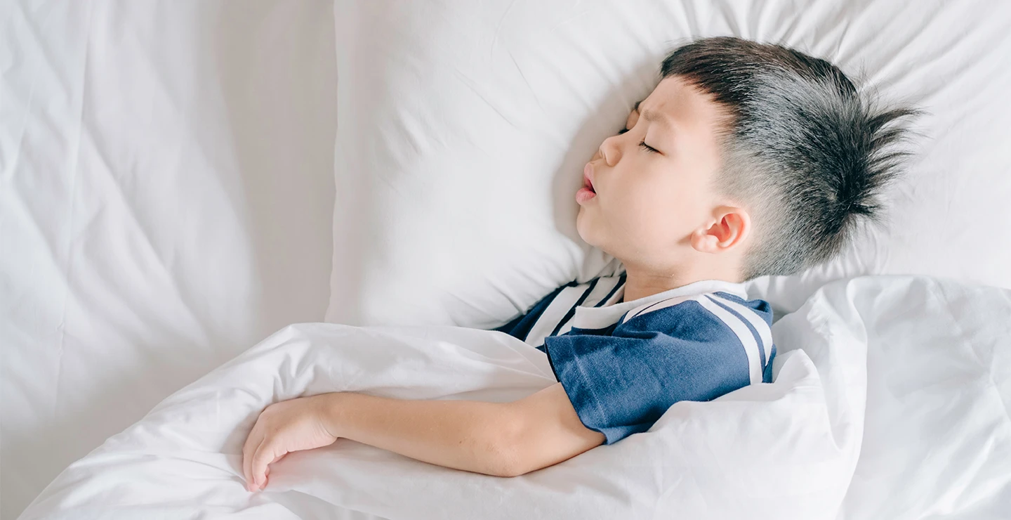 Little boy sleeping in his bed 