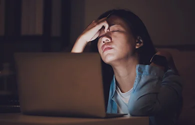 Tired woman working late 